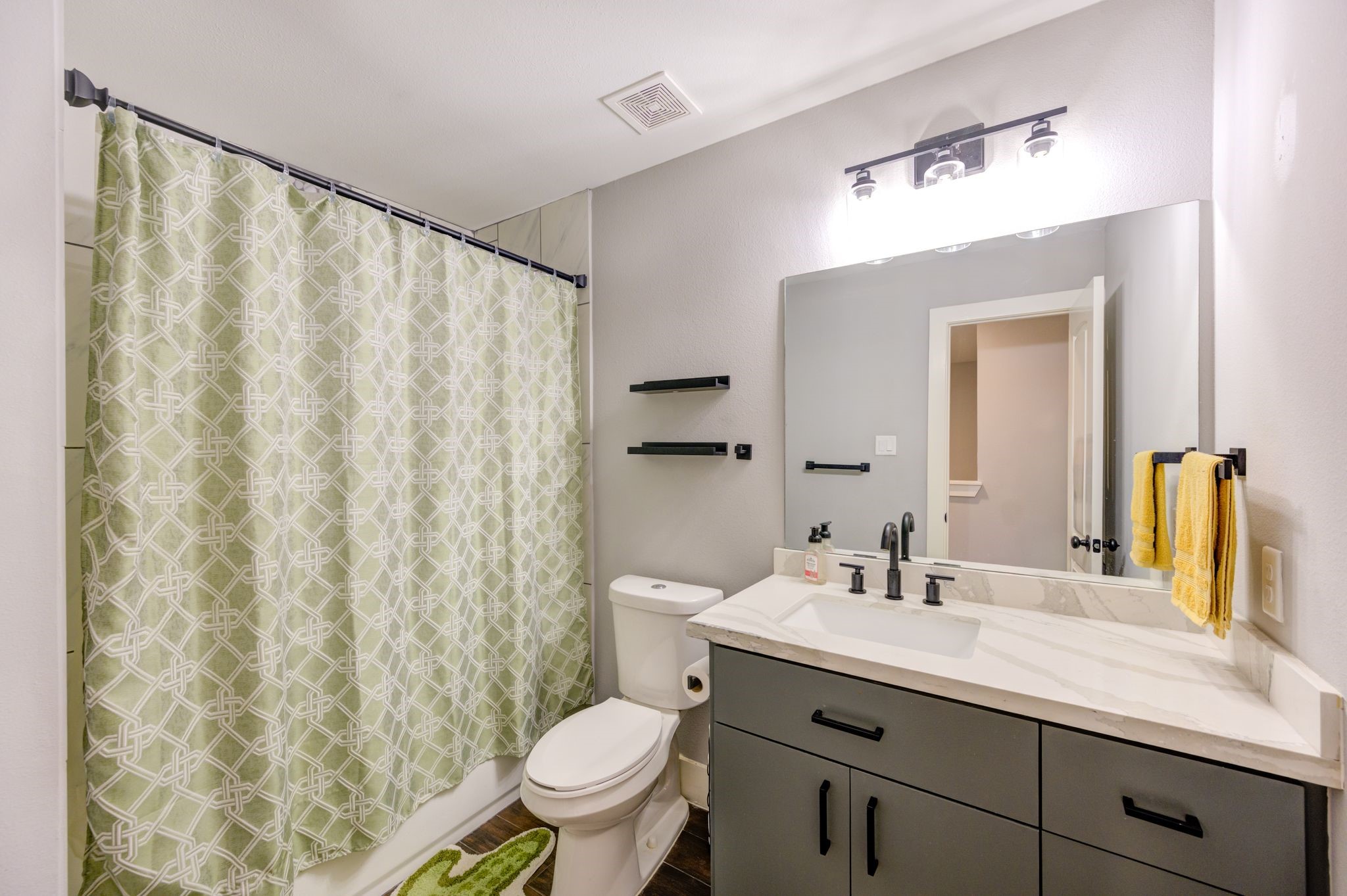 436 Owens Street Houston, TX 77029 - Photo 21 of 33 a bathroom with a granite countertop sink and a mirror