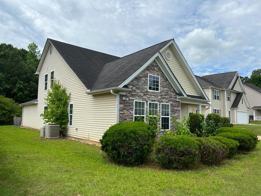 a front view of a house with a garden