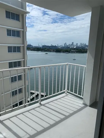 a roof deck with outdoor seating and lake view