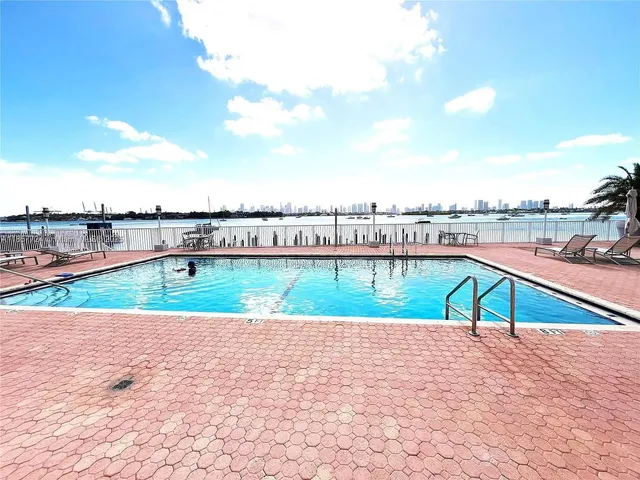 a view of a hallway with wooden floor and furniture