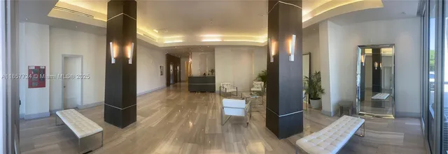 a living room with furniture and a mirror