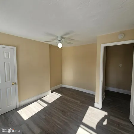 an empty room with wooden floor and closet
