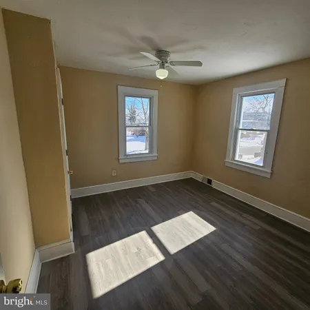 a view of wooden floor and windows in a room