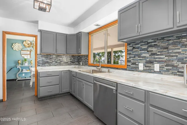 a kitchen with cabinets appliances a sink and a window