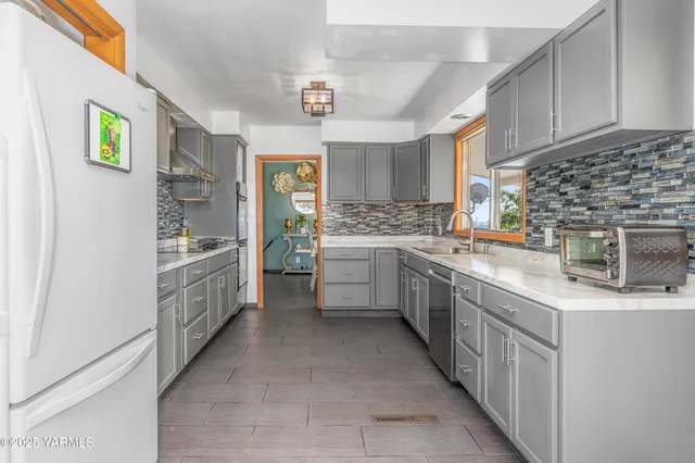 a kitchen with stainless steel appliances a sink and counter top