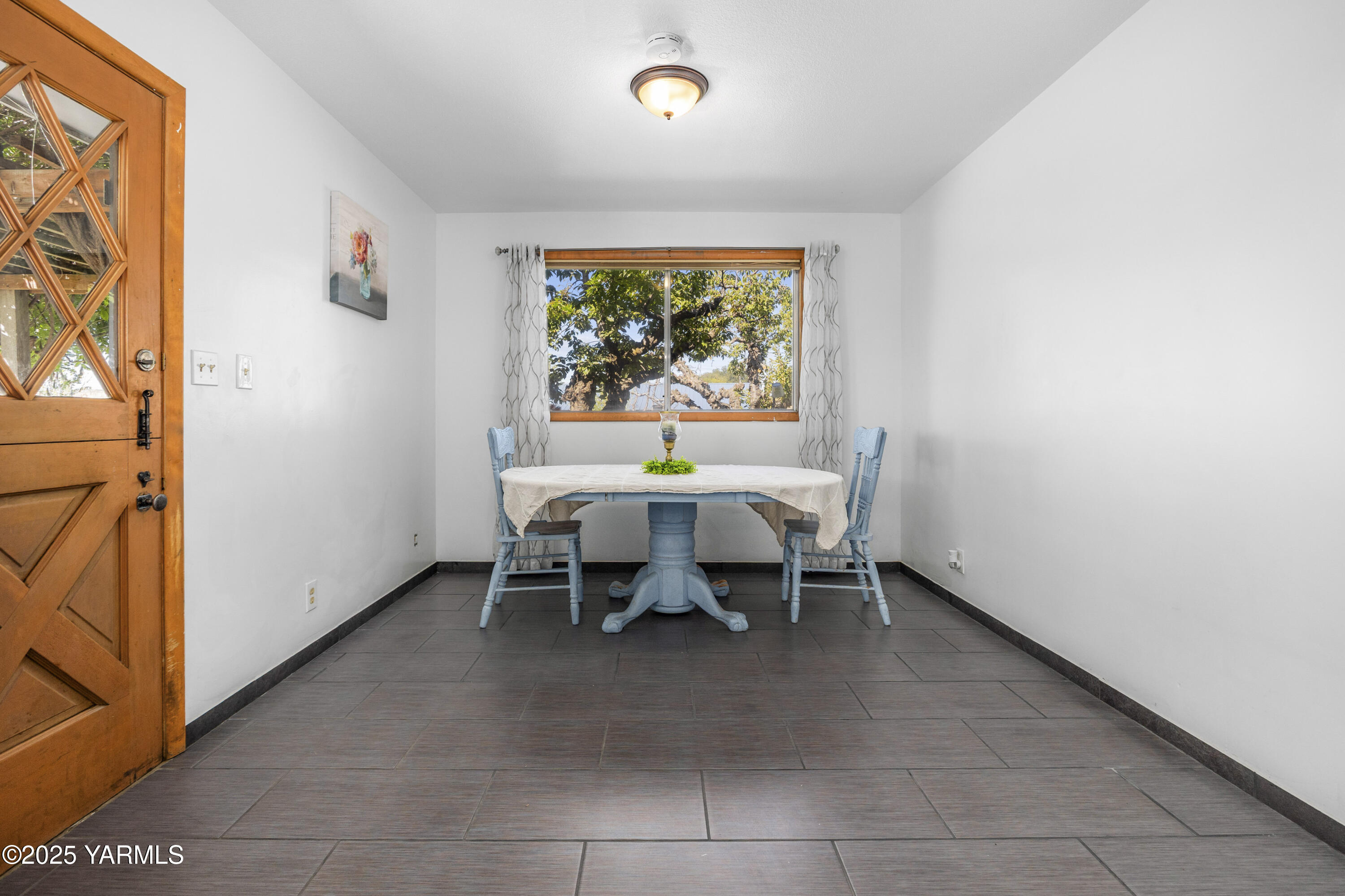 1381 West Riverside Avenue Sunnyside, WA 98944 - Photo 14 of 53 a dining room with furniture and a floor to ceiling window
