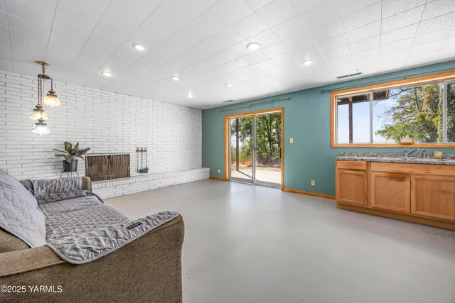 a kitchen with granite countertop stainless steel appliances a refrigerator a sink and cabinets