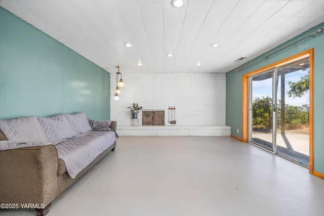 a living room with furniture and a kitchen
