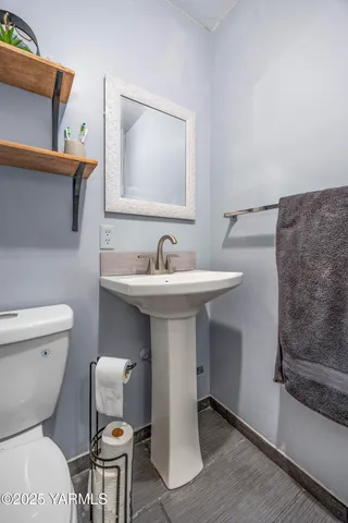 a bathroom with a toilet sink and mirror