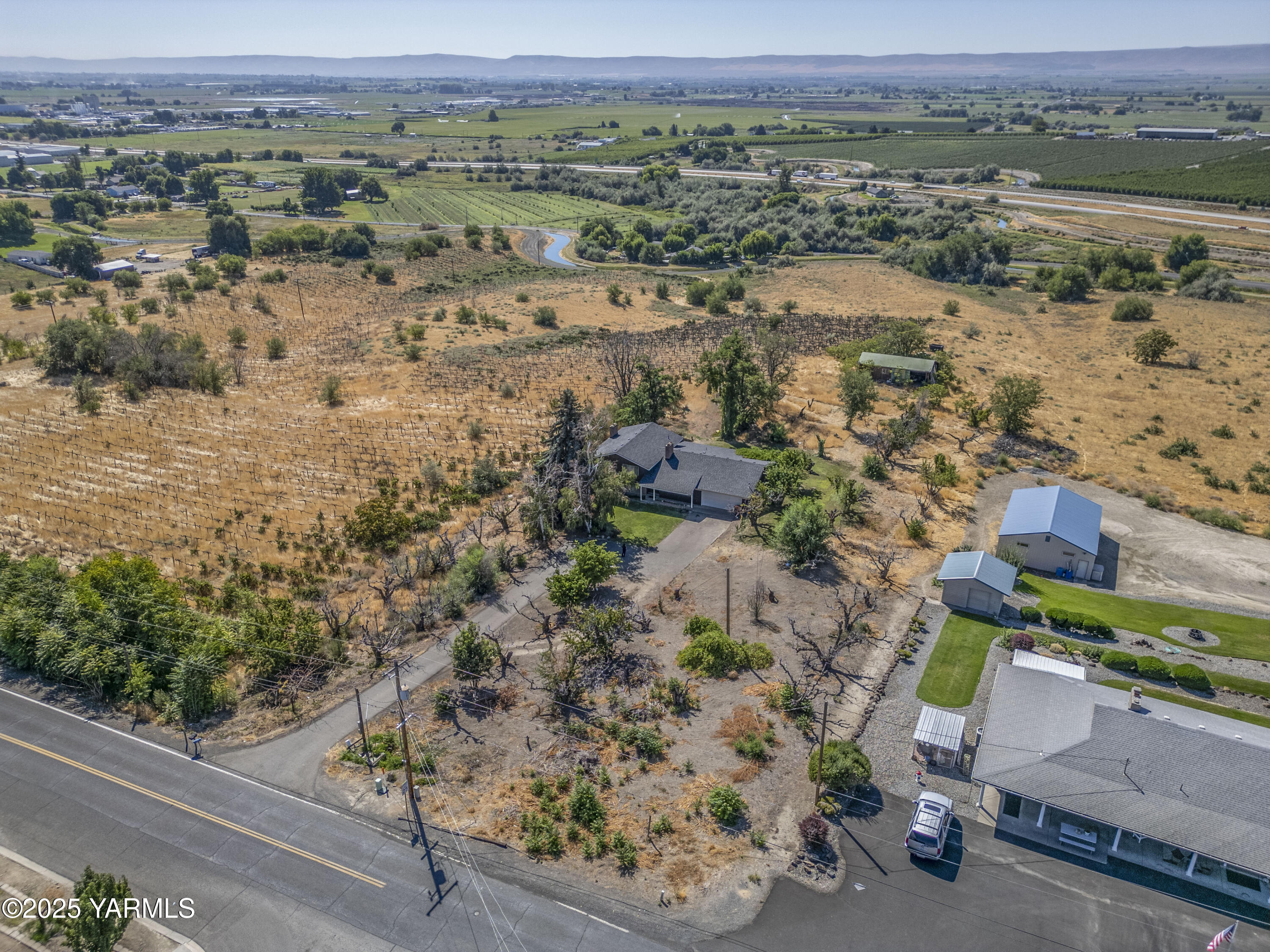 1381 West Riverside Avenue Sunnyside, WA 98944 - Photo 35 of 53 an aerial view of a house with a yard