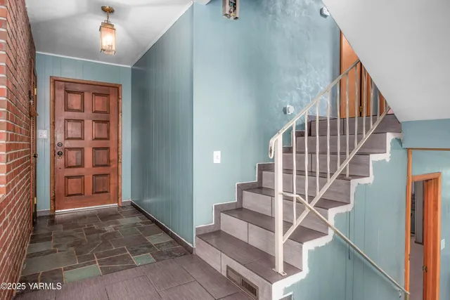 a view of entryway and hall with a front door