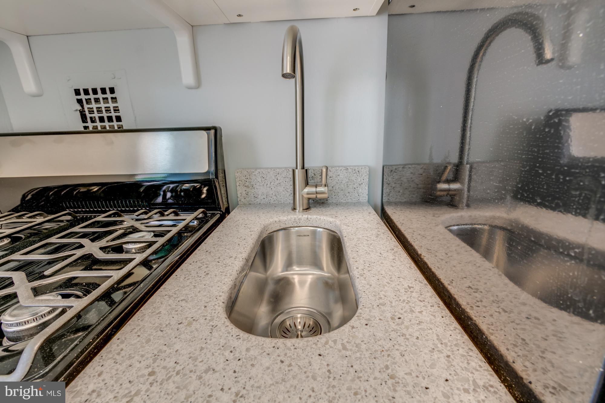 1021 Arlington Boulevard, Unit 647 Arlington, VA 22209 - Photo 12 of 17 a kitchen with a sink a stove and a microwave