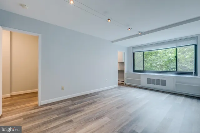 wooden floor in an empty room with a window