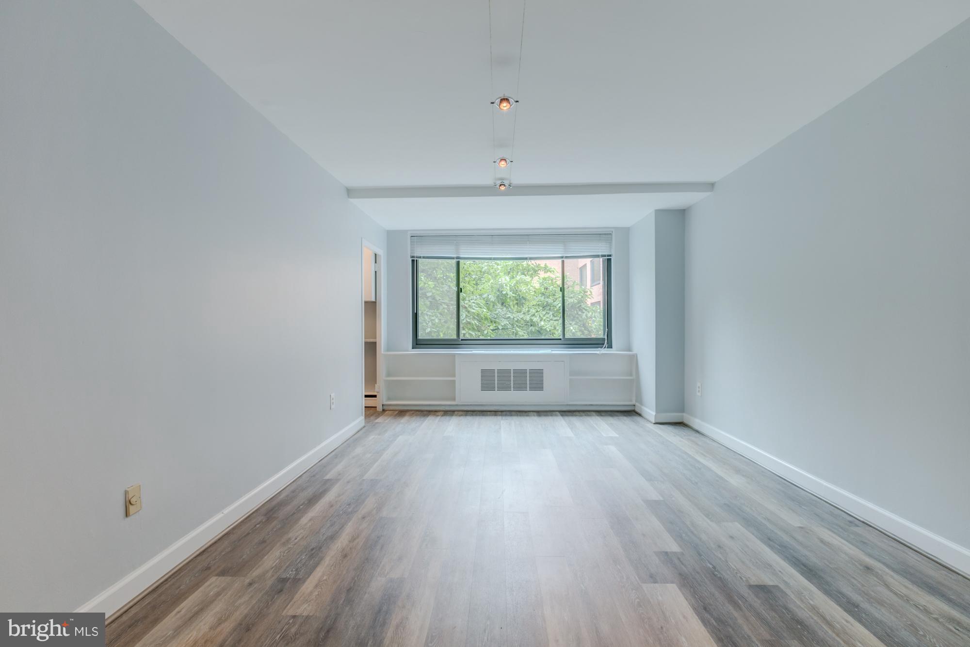 1021 Arlington Boulevard, Unit 647 Arlington, VA 22209 - Photo 7 of 17 wooden floor in an empty room with a window