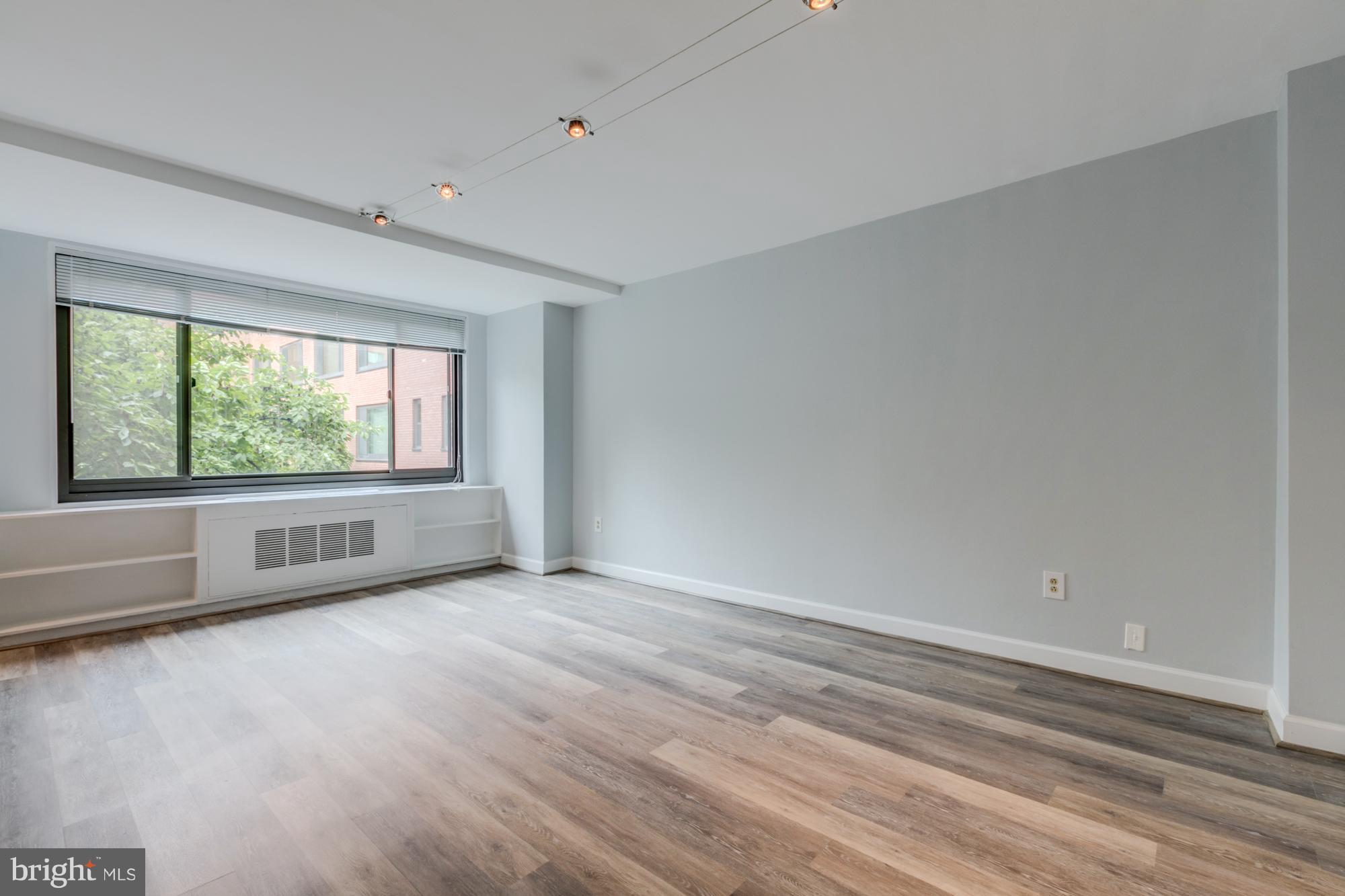 1021 Arlington Boulevard, Unit 647 Arlington, VA 22209 - Photo 9 of 17 wooden floor in an empty room with a window