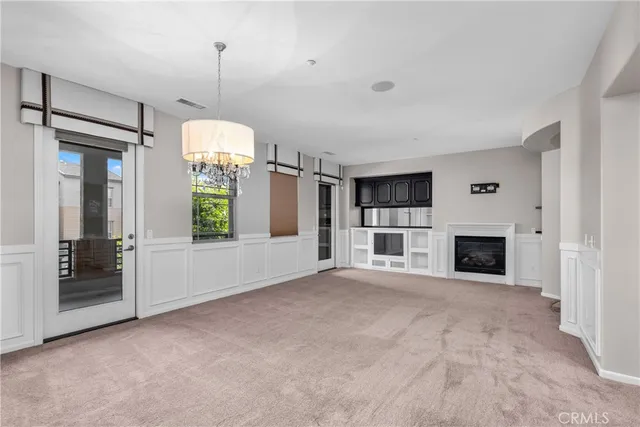 a view of a livingroom with a fireplace and window