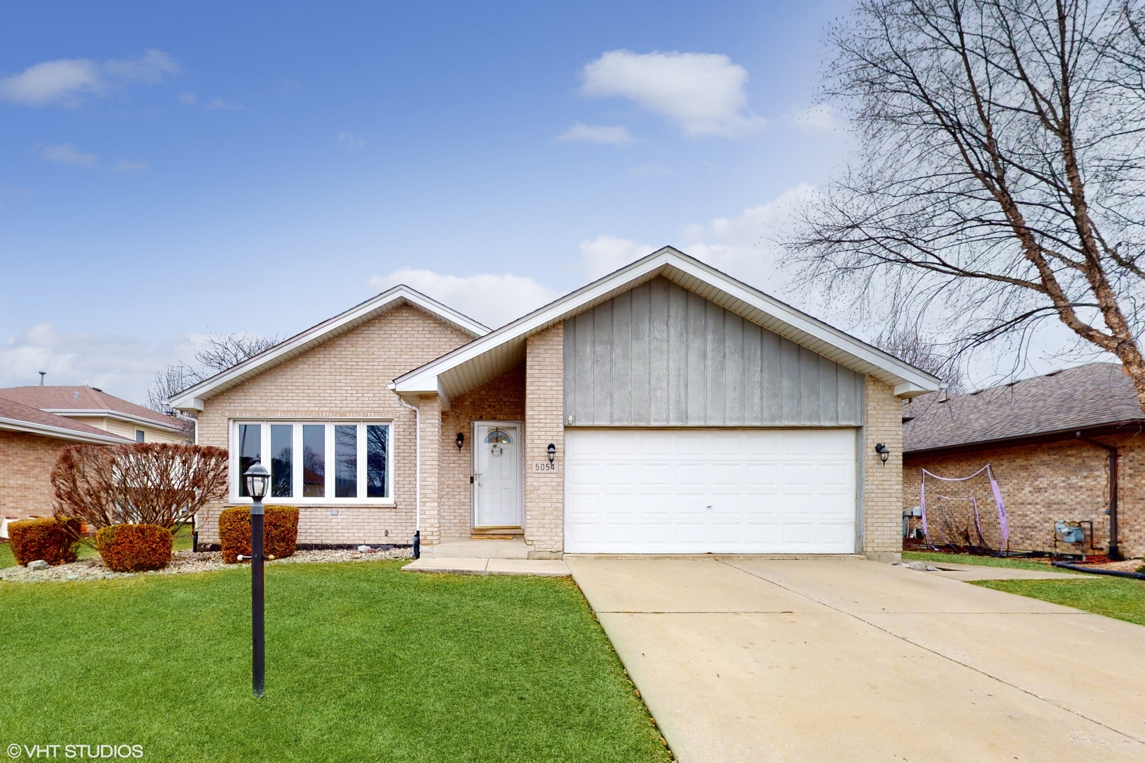 a view of an house with backyard space and garden