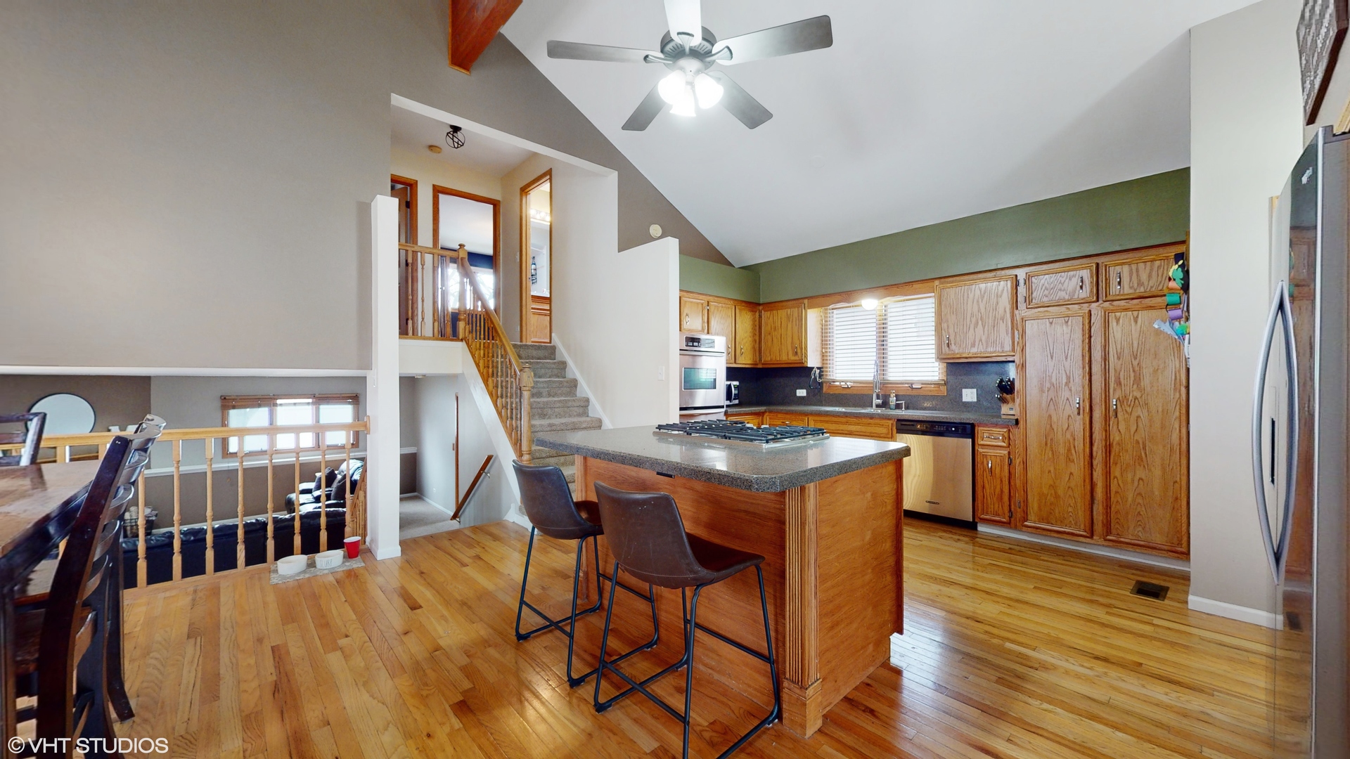 5054 Arrowhead Trace Oak Forest, IL 60452 - Photo 7 of 27 a kitchen with stainless steel appliances granite countertop a refrigerator a stove a sink dishwasher with a dining table and chairs