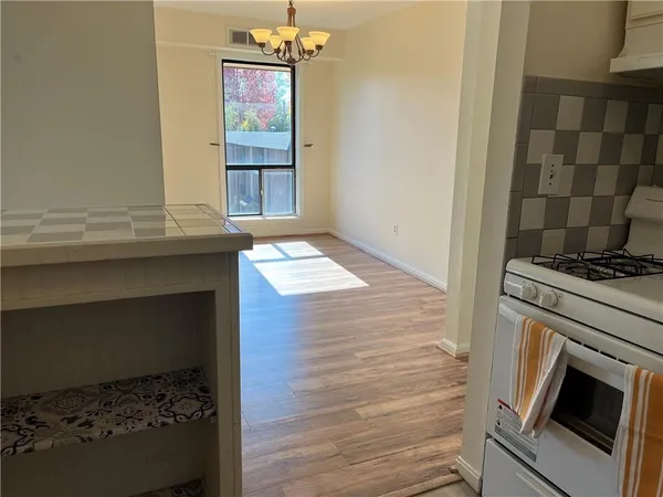a kitchen with a stove and a cabinet