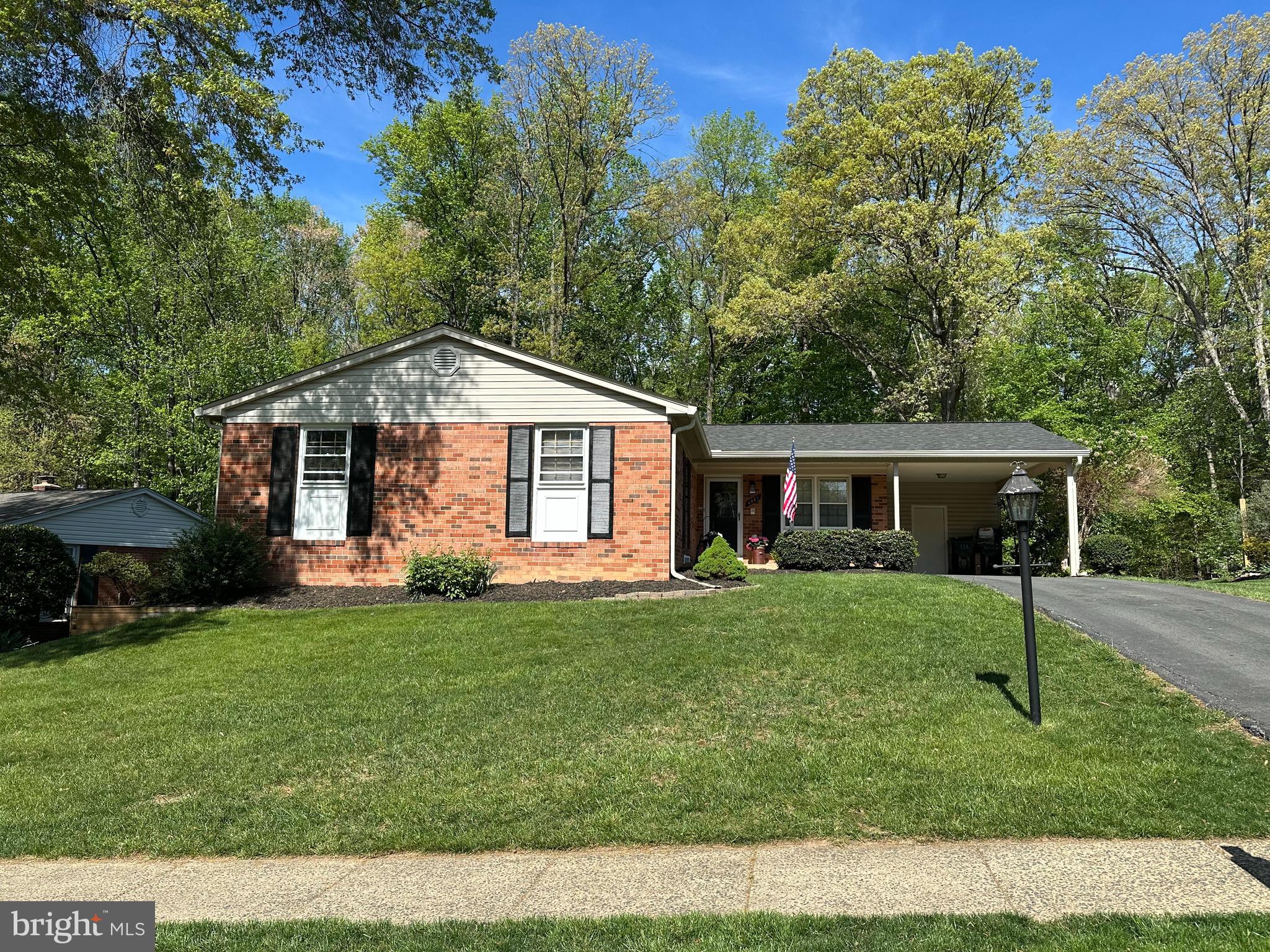 6961 Conservation Drive Springfield, VA 22153 - Photo 1 of 62 a front view of a house with a garden
