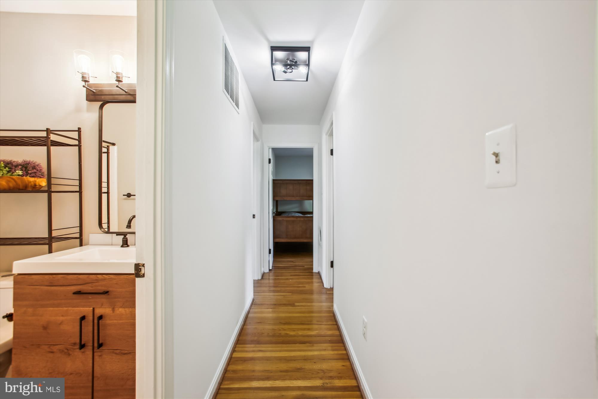 6961 Conservation Drive Springfield, VA 22153 - Photo 18 of 62 a view of a hallway with wooden floor
