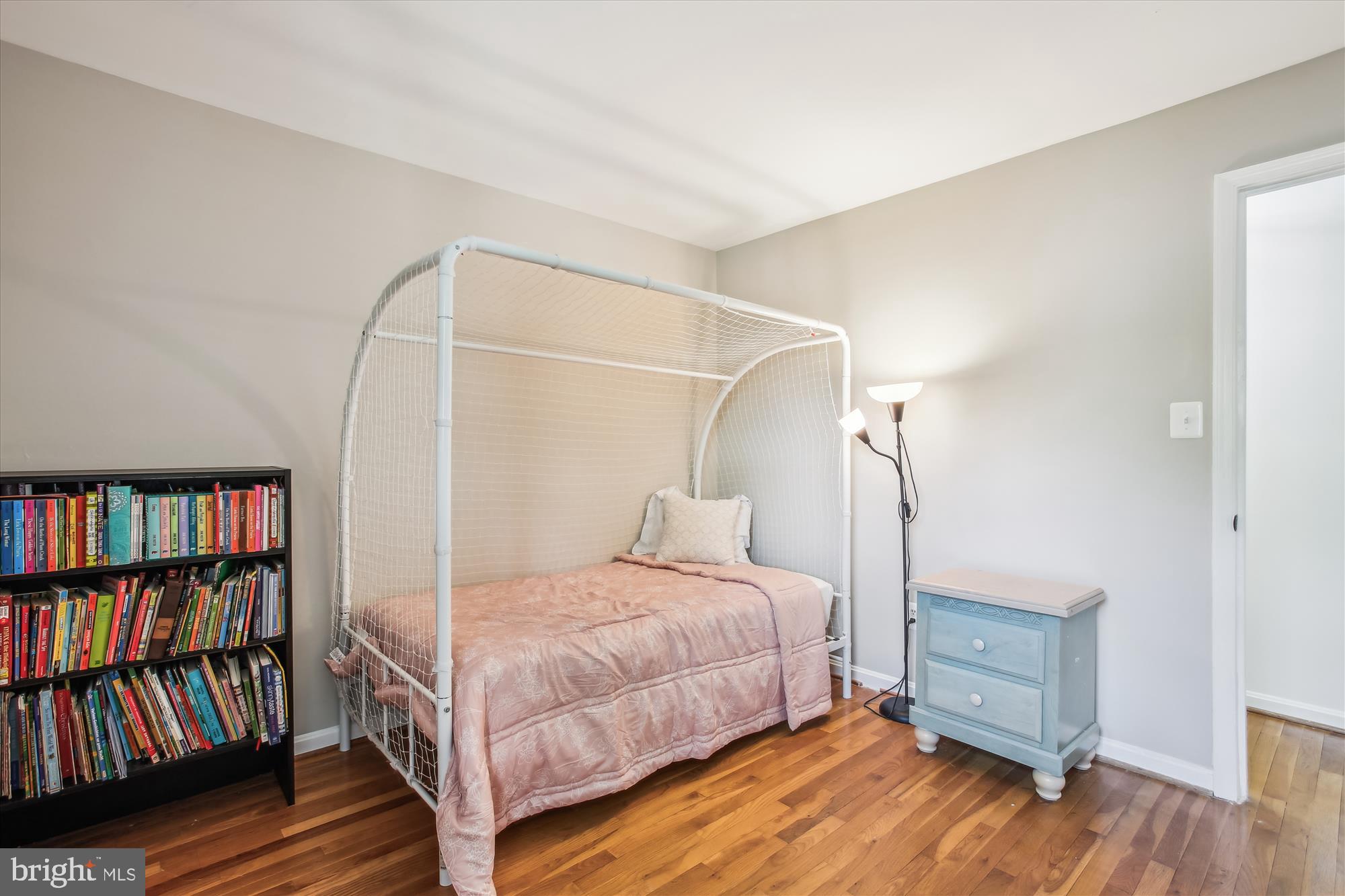 6961 Conservation Drive Springfield, VA 22153 - Photo 22 of 62 a bedroom with a bed and a book shelf