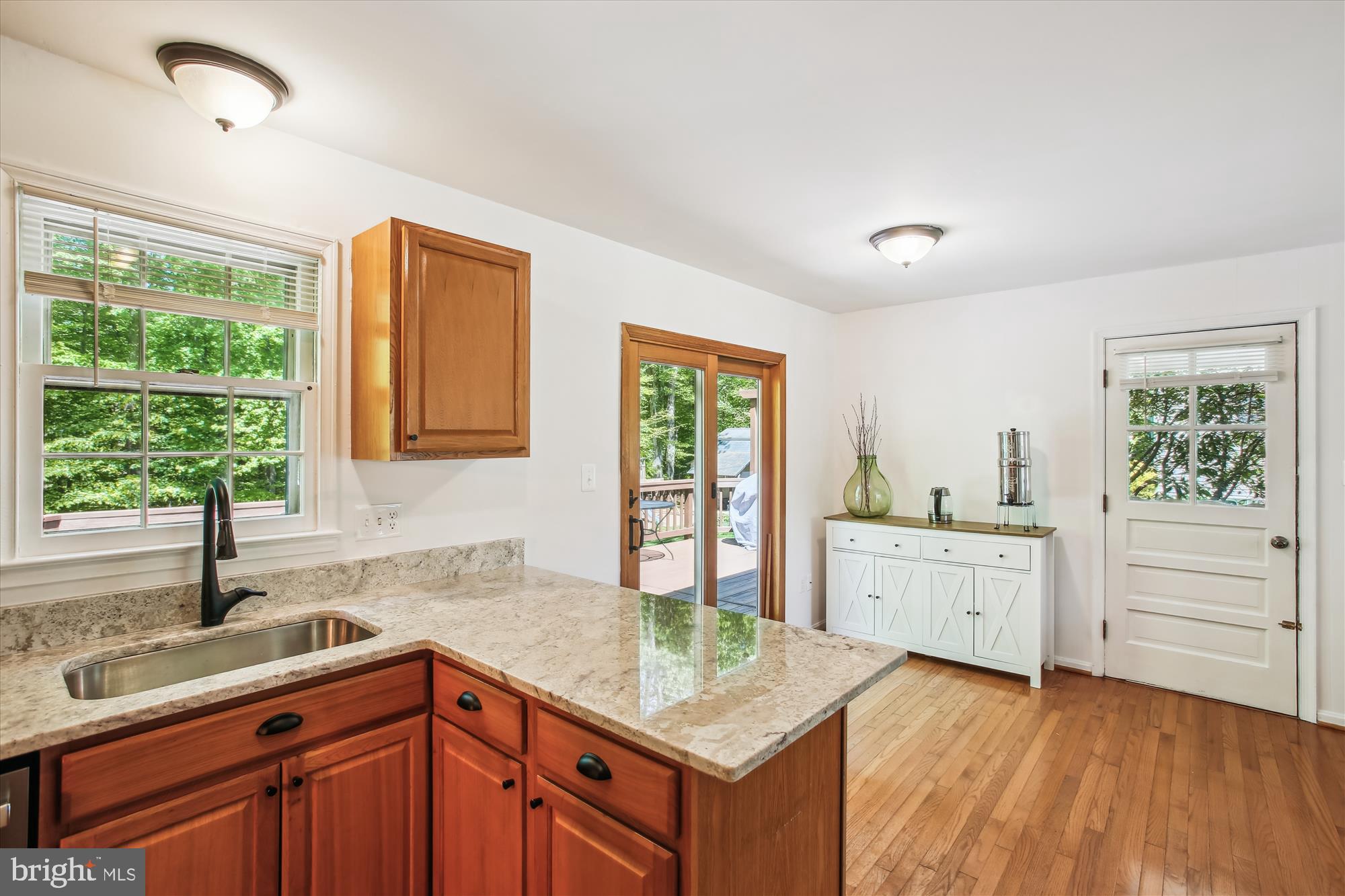 6961 Conservation Drive Springfield, VA 22153 - Photo 26 of 62 a kitchen with a sink stove and cabinets