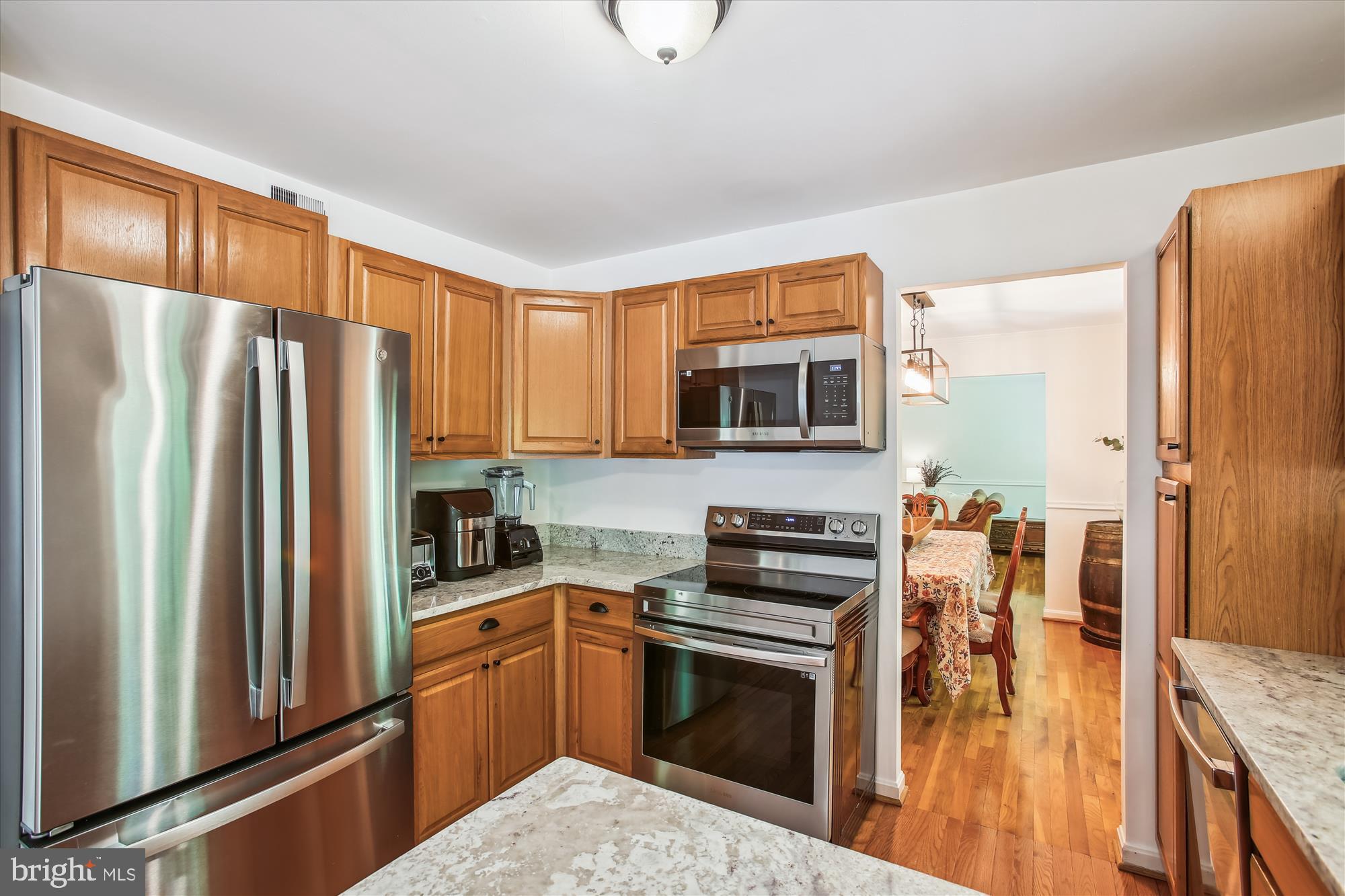 6961 Conservation Drive Springfield, VA 22153 - Photo 27 of 62 a kitchen with stainless steel appliances a refrigerator a stove a sink and a refrigerator