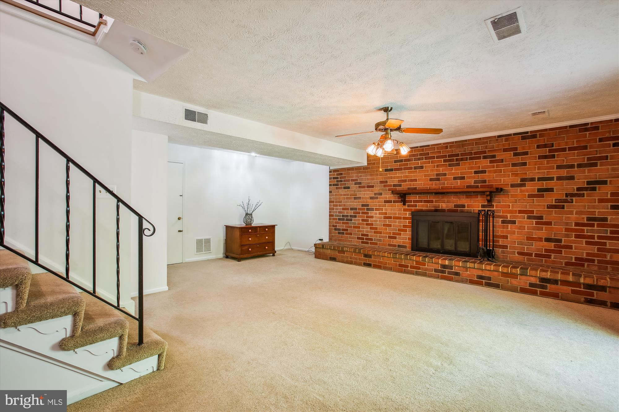 6961 Conservation Drive Springfield, VA 22153 - Photo 39 of 62 a view of a livingroom with an empty space and a fireplace