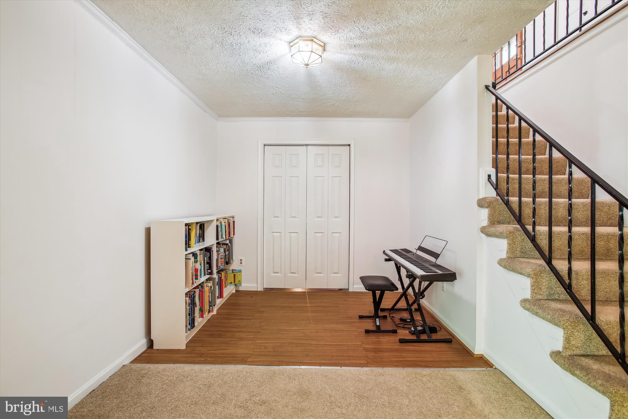 6961 Conservation Drive Springfield, VA 22153 - Photo 40 of 62 a view of a hallway with wooden floor and stairs