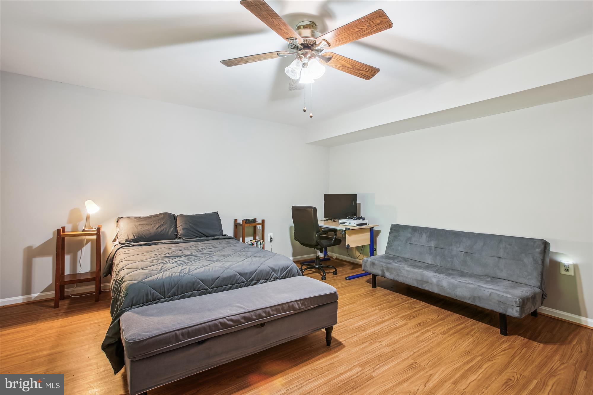 6961 Conservation Drive Springfield, VA 22153 - Photo 41 of 62 a spacious bedroom with a bed a couch and a chandelier