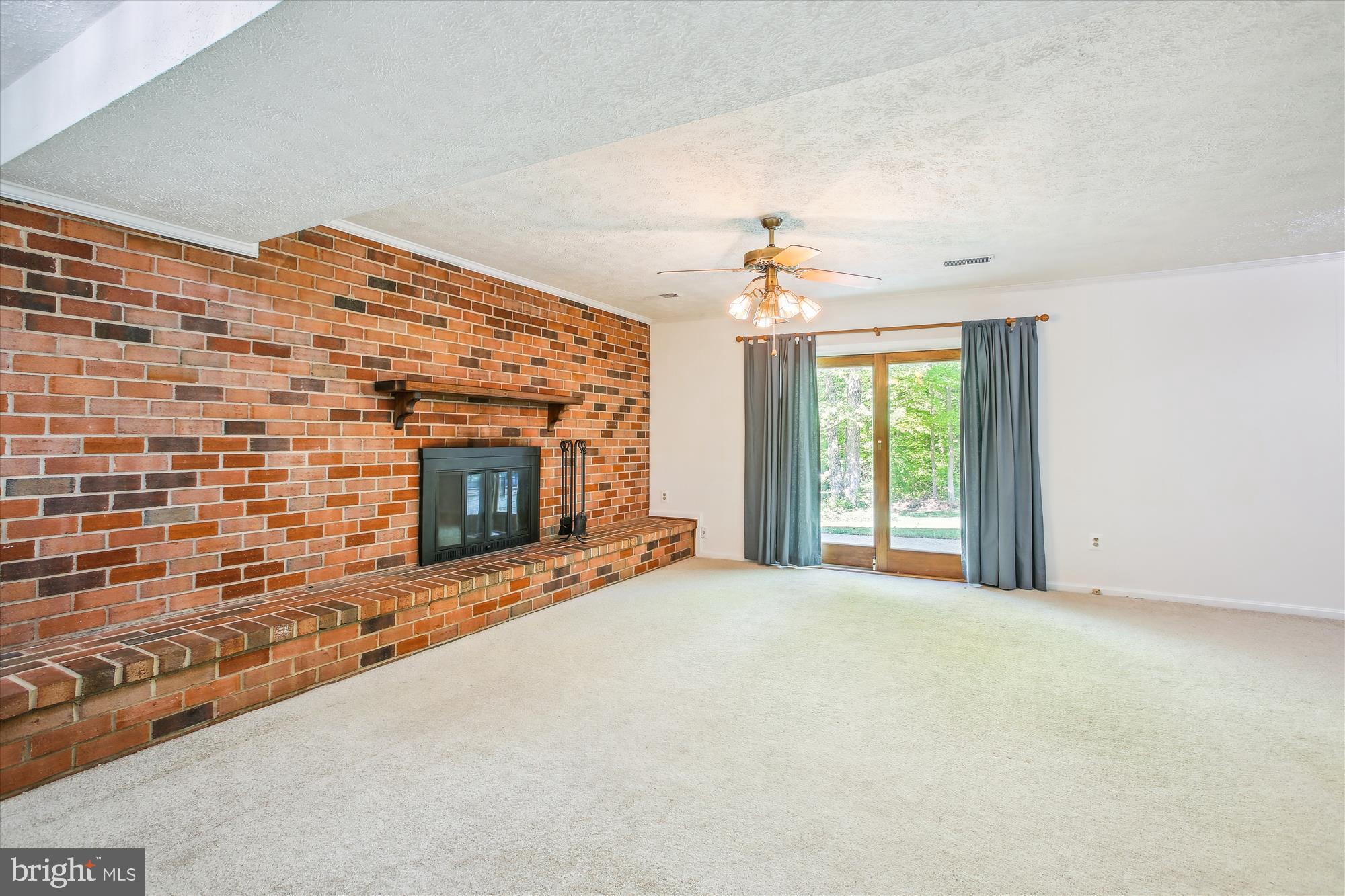 6961 Conservation Drive Springfield, VA 22153 - Photo 43 of 62 a view of an empty room with a fireplace and a window