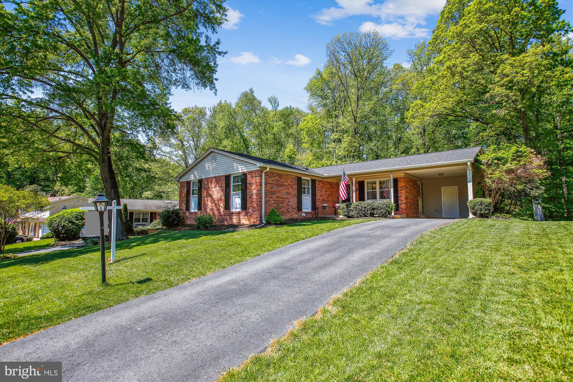 6961 Conservation Drive Springfield, VA 22153 - Photo 5 of 62 a front view of a house with a yard and trees