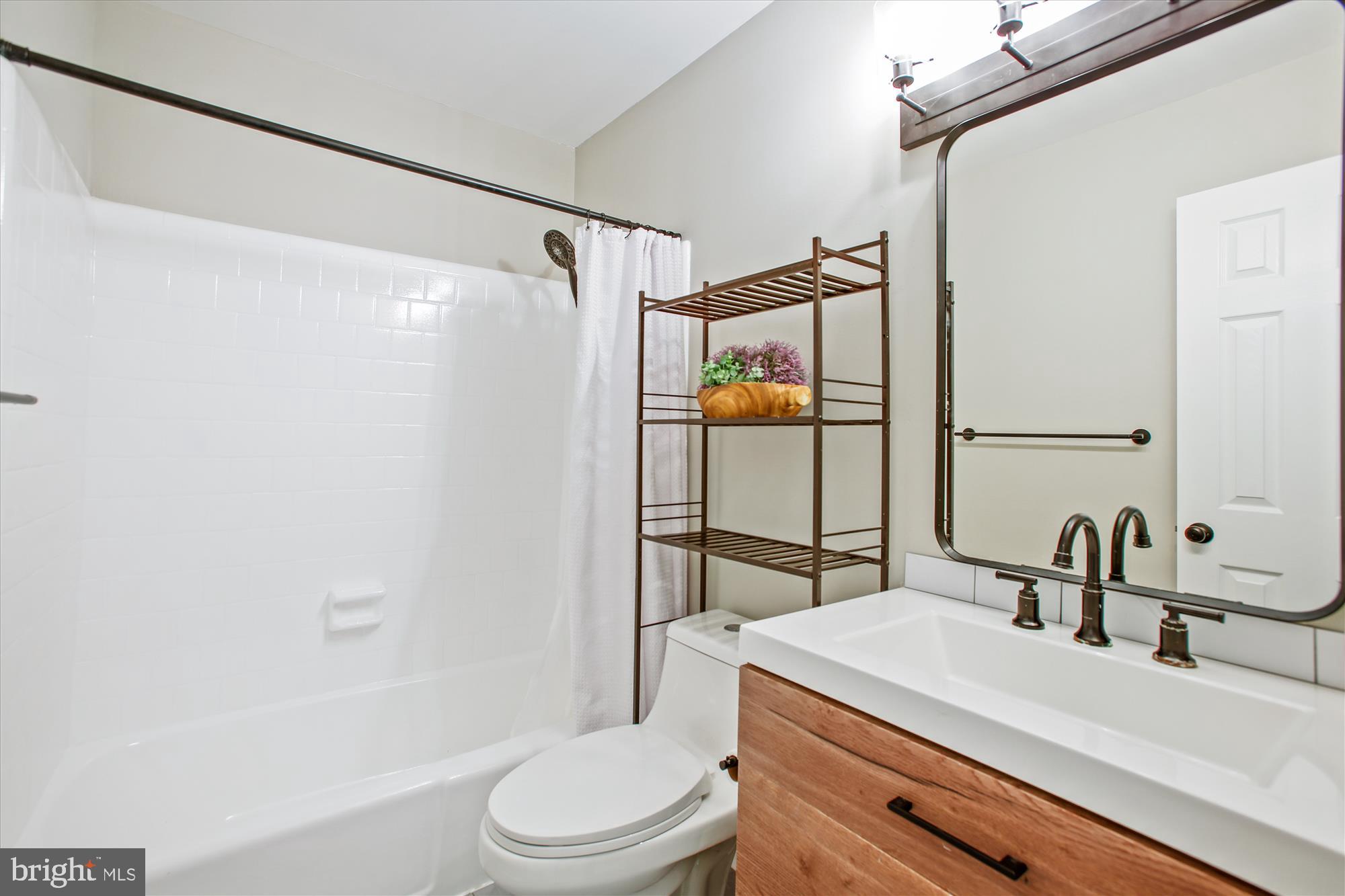 6961 Conservation Drive Springfield, VA 22153 - Photo 8 of 62 a bathroom with a sink toilet and shower