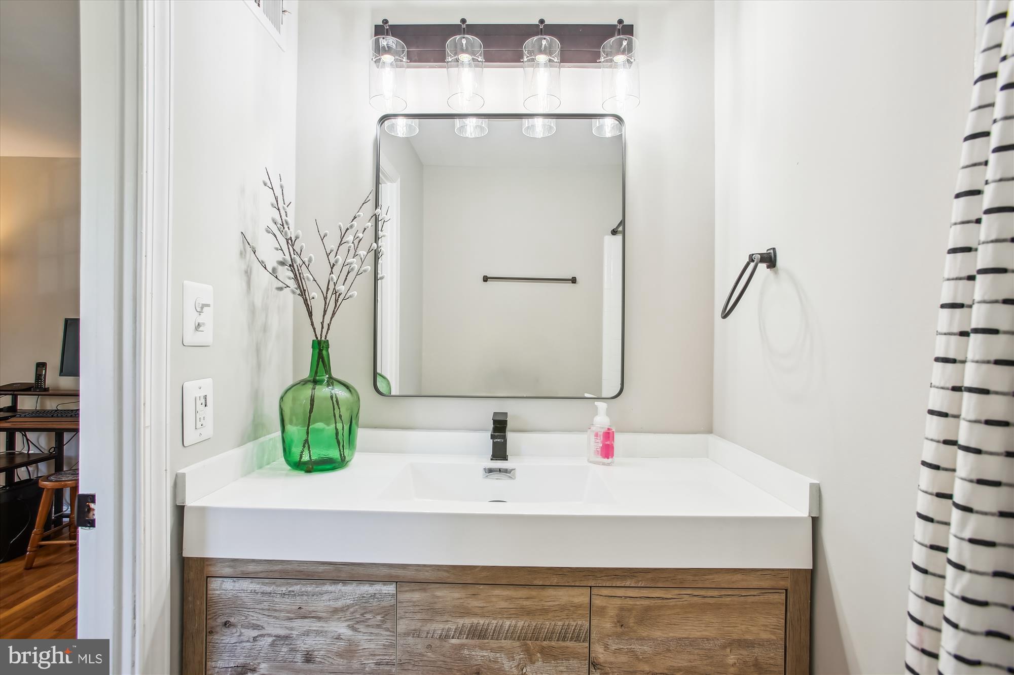 6961 Conservation Drive Springfield, VA 22153 - Photo 9 of 62 a bathroom with a sink and a mirror