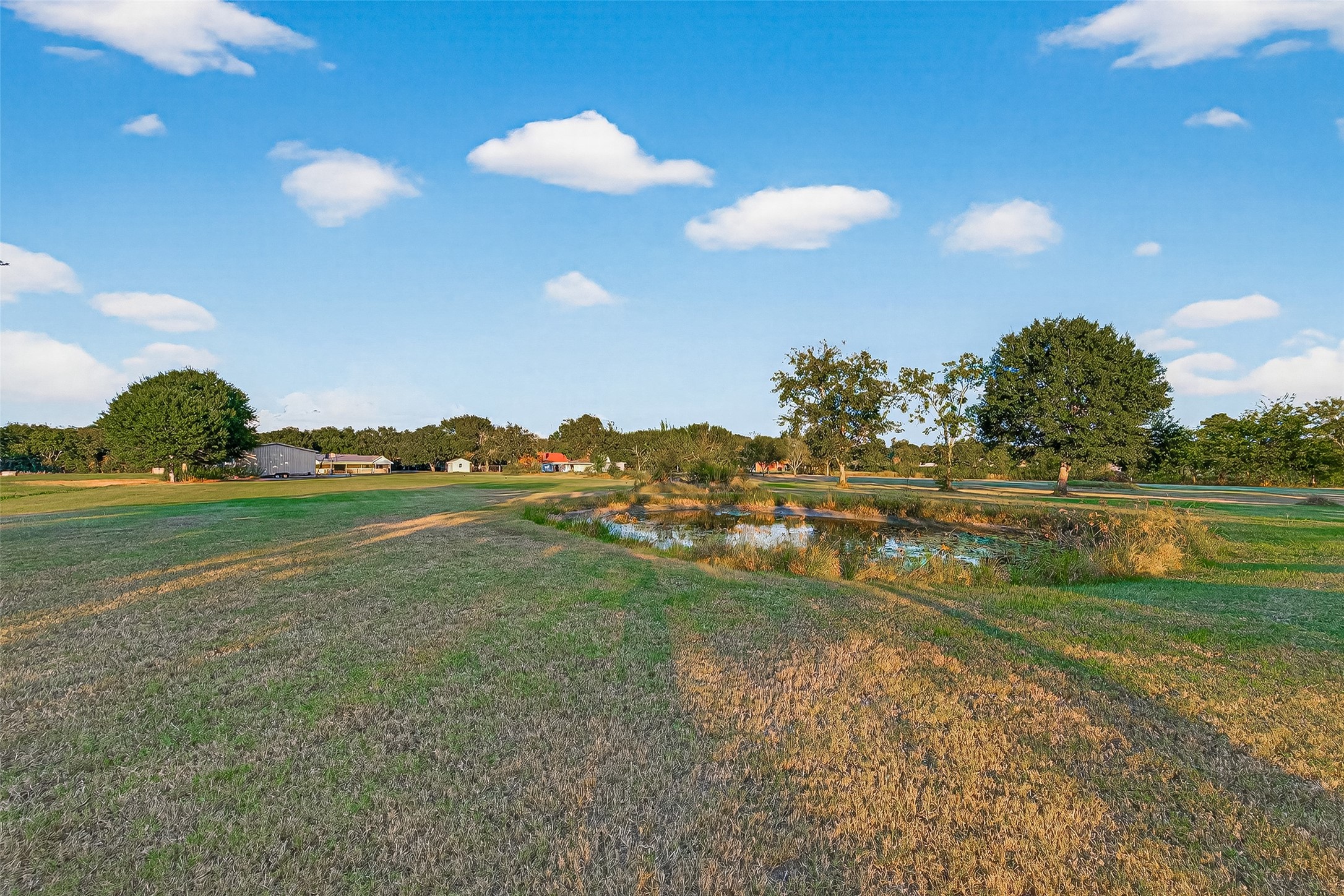 3122 Kueck Road Rosenberg, TX 77471 - Photo 22 of 25 a view of a golf course with a lake
