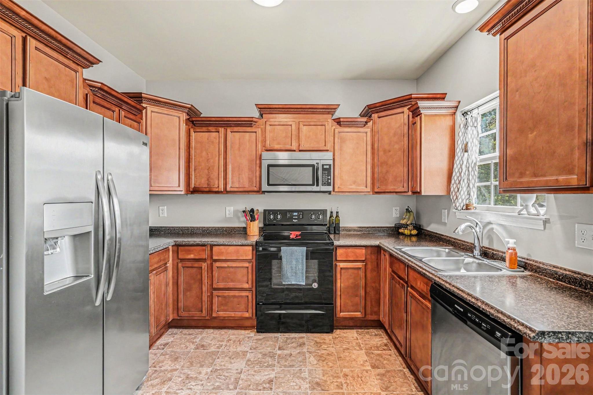 1610 Walter Hasty Road Monroe, NC 28110 - Photo 8 of 32 a kitchen with stainless steel appliances granite countertop a refrigerator and a sink