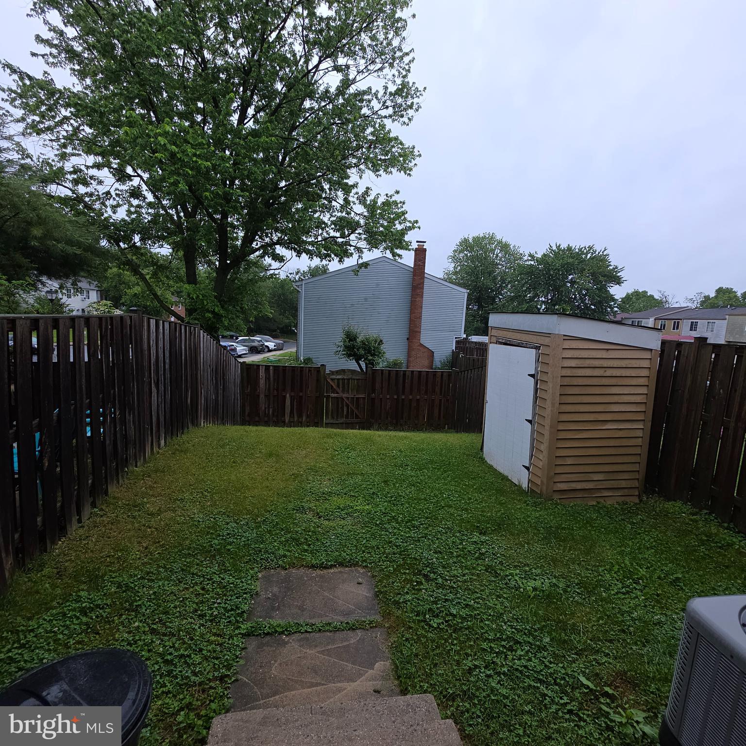 1758 Springfield Lane Frederick, MD 21702 - Photo 29 of 31 a view of a backyard with large trees and wooden fence