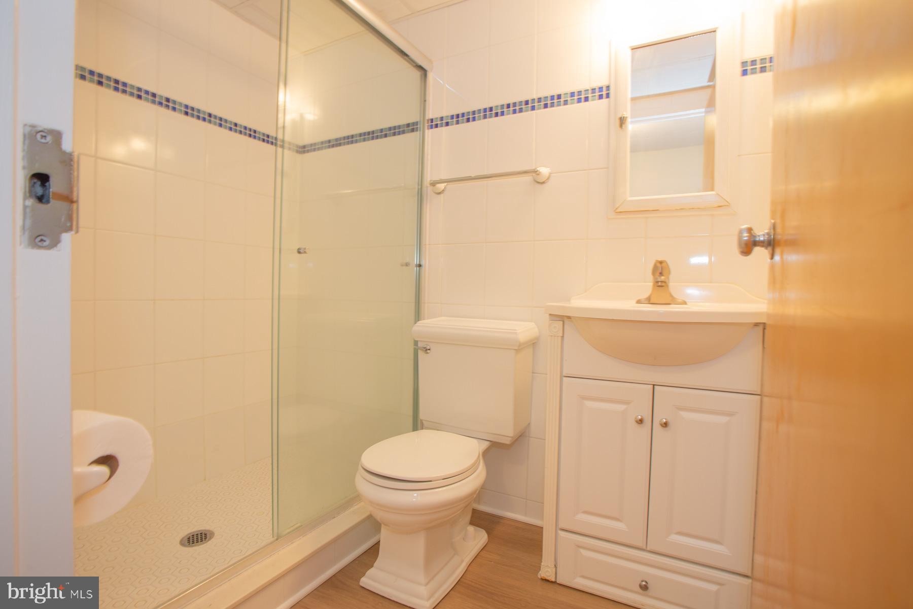 409 Rehoboth Avenue, Unit 20 Rehoboth Beach, DE 19971 - Photo 10 of 31 a bathroom with a sink a toilet and shower