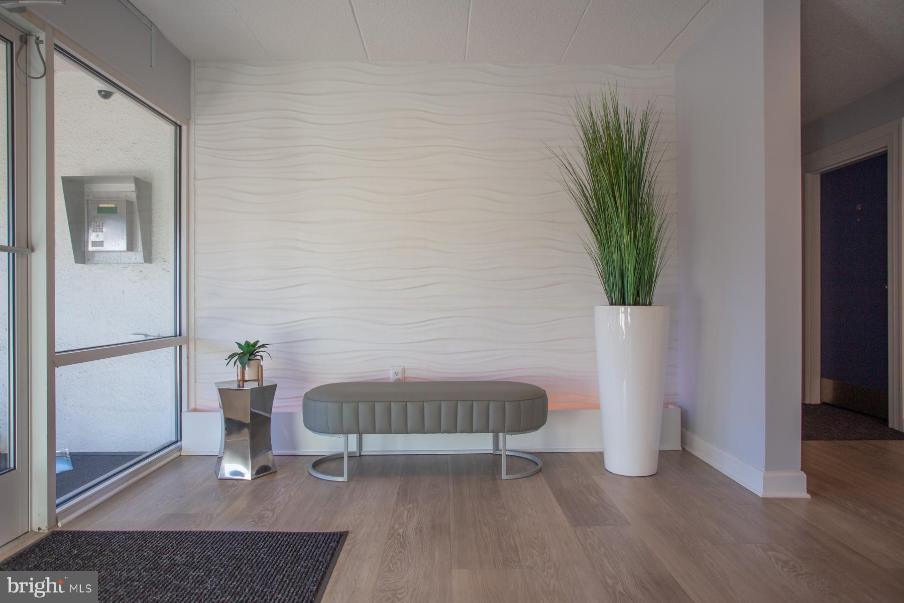 409 Rehoboth Avenue, Unit 20 Rehoboth Beach, DE 19971 - Photo 30 of 31 a living room with furniture and a potted plant