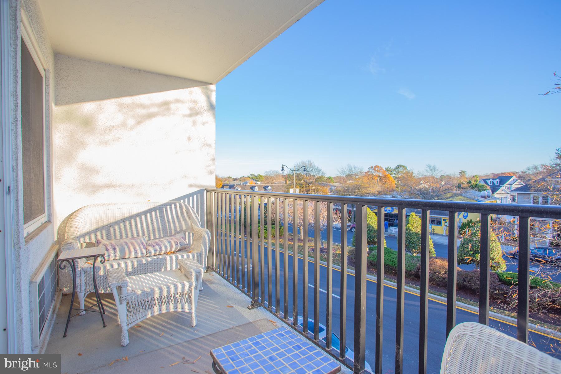 409 Rehoboth Avenue, Unit 20 Rehoboth Beach, DE 19971 - Photo 8 of 31 a view of a chair and table in the balcony