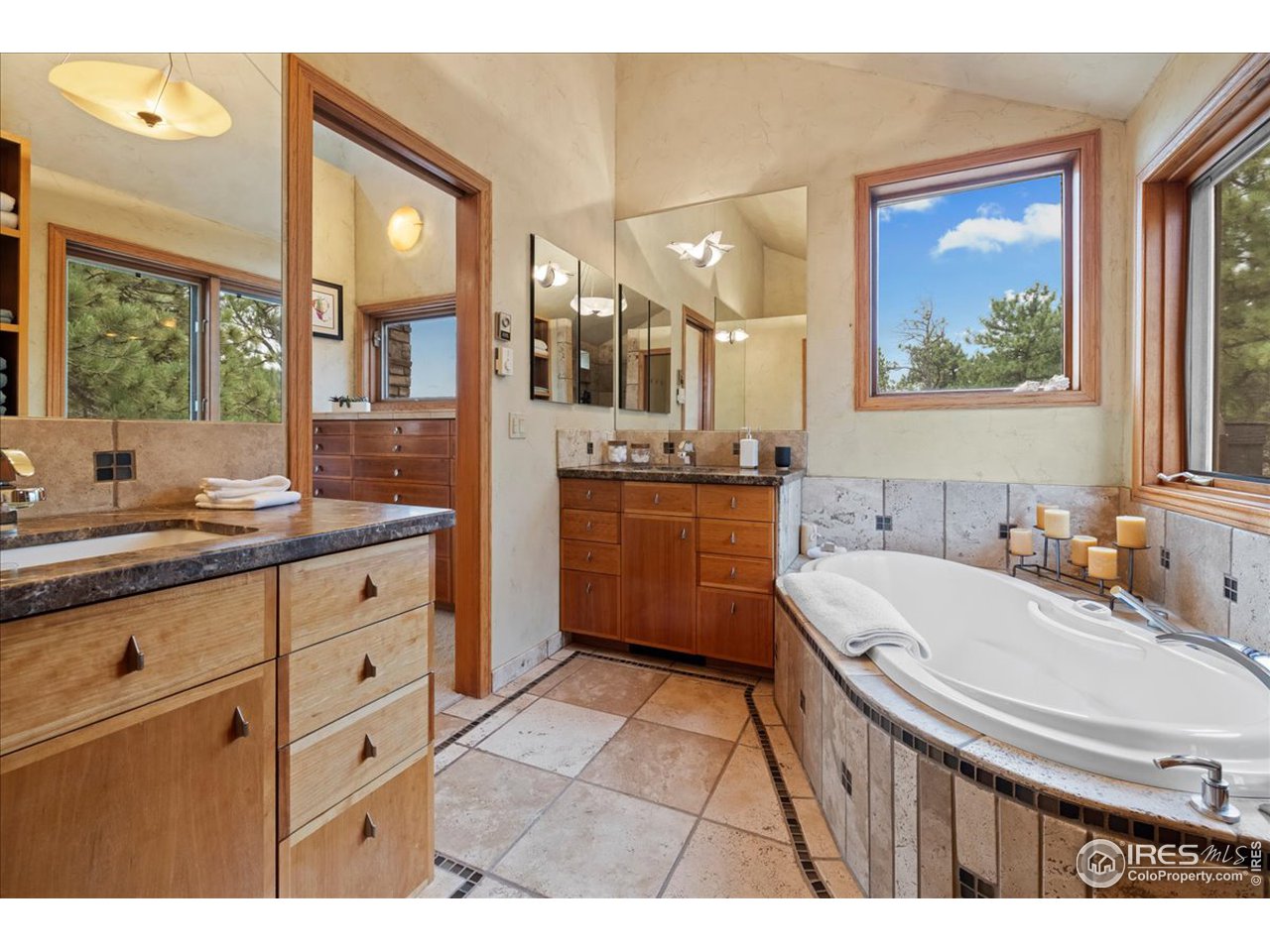 6293 Red Hill Road Boulder, CO 80302 - Photo 21 of 40 a bathroom with a granite countertop sink mirror and a bathtub