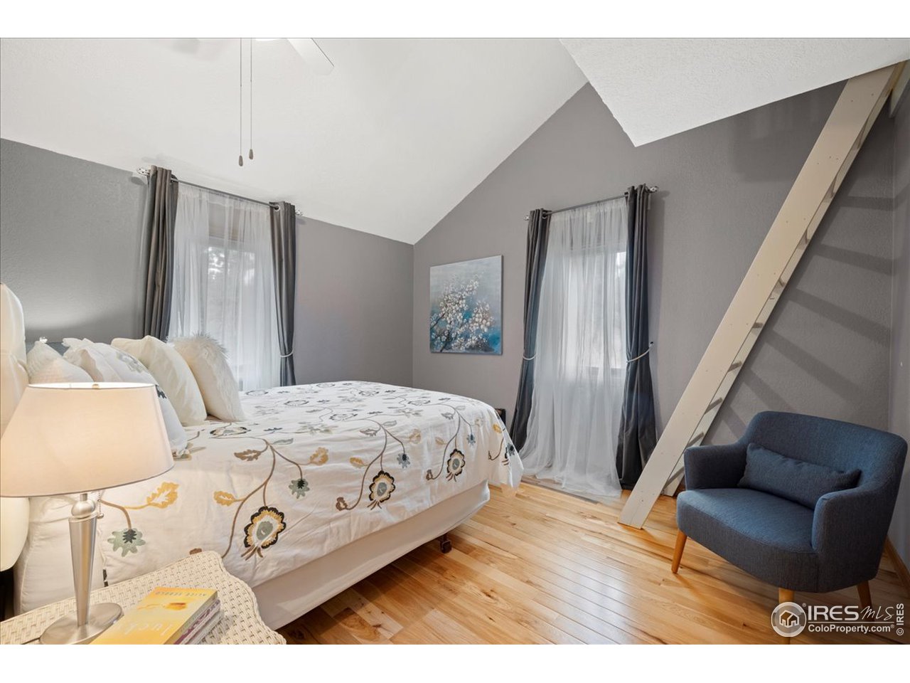 6293 Red Hill Road Boulder, CO 80302 - Photo 23 of 40 a bedroom with a bed with wooden floor