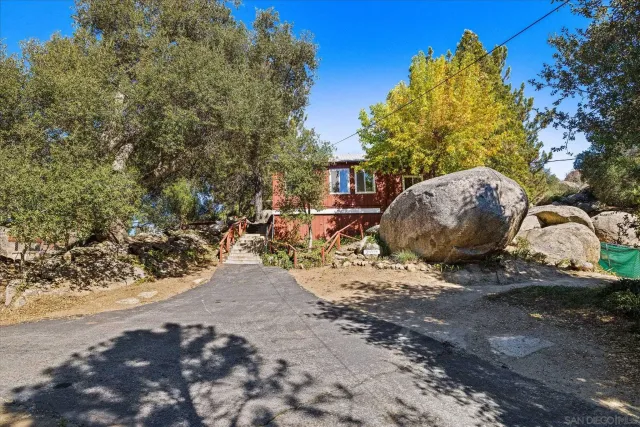 a view of a dirt road with a building in the background