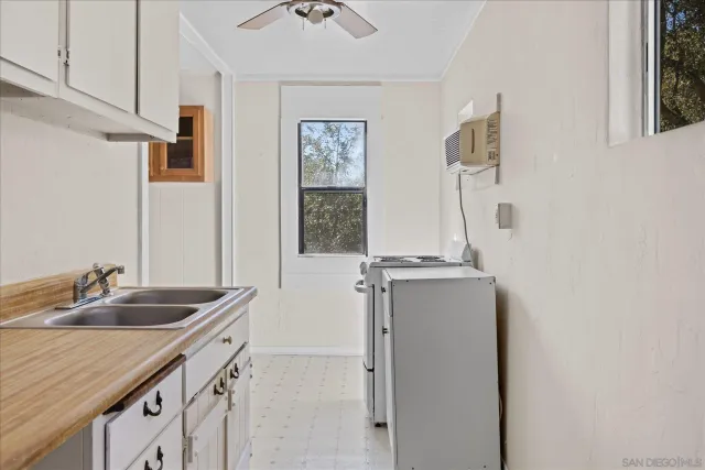 a kitchen with a sink and a refrigerator