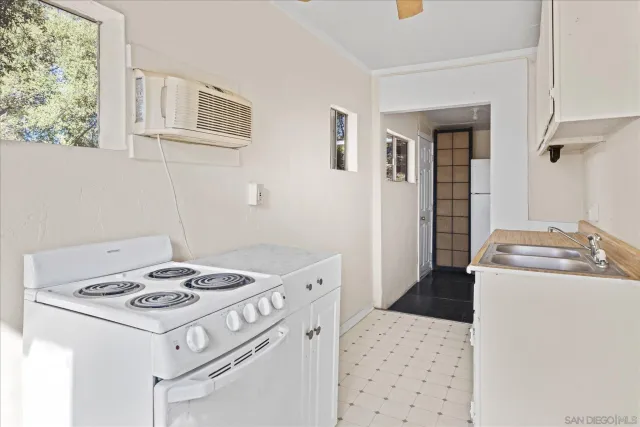 a kitchen that has a stove and a table