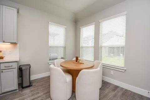 a dining room with furniture and window