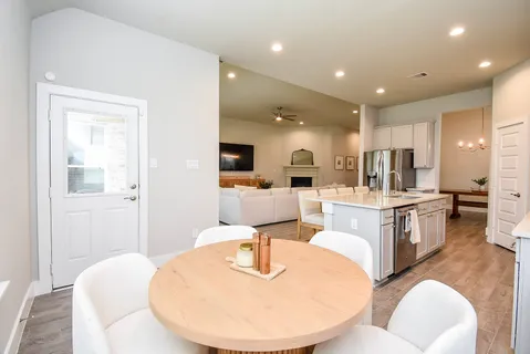 a living room with kitchen island furniture and a view of kitchen