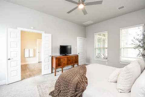 a bedroom with a bed and a flat screen tv
