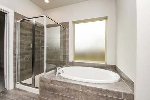 a bathroom with a bathtub and shower
